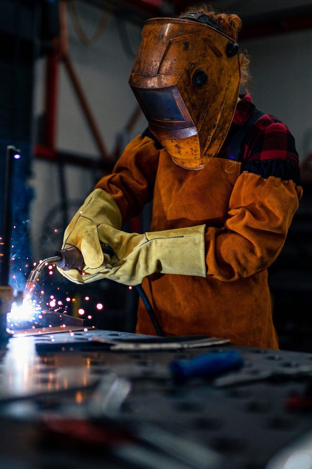 A,Woman,In,Protective,Equipment,Uses,Tools,And,Machines,In